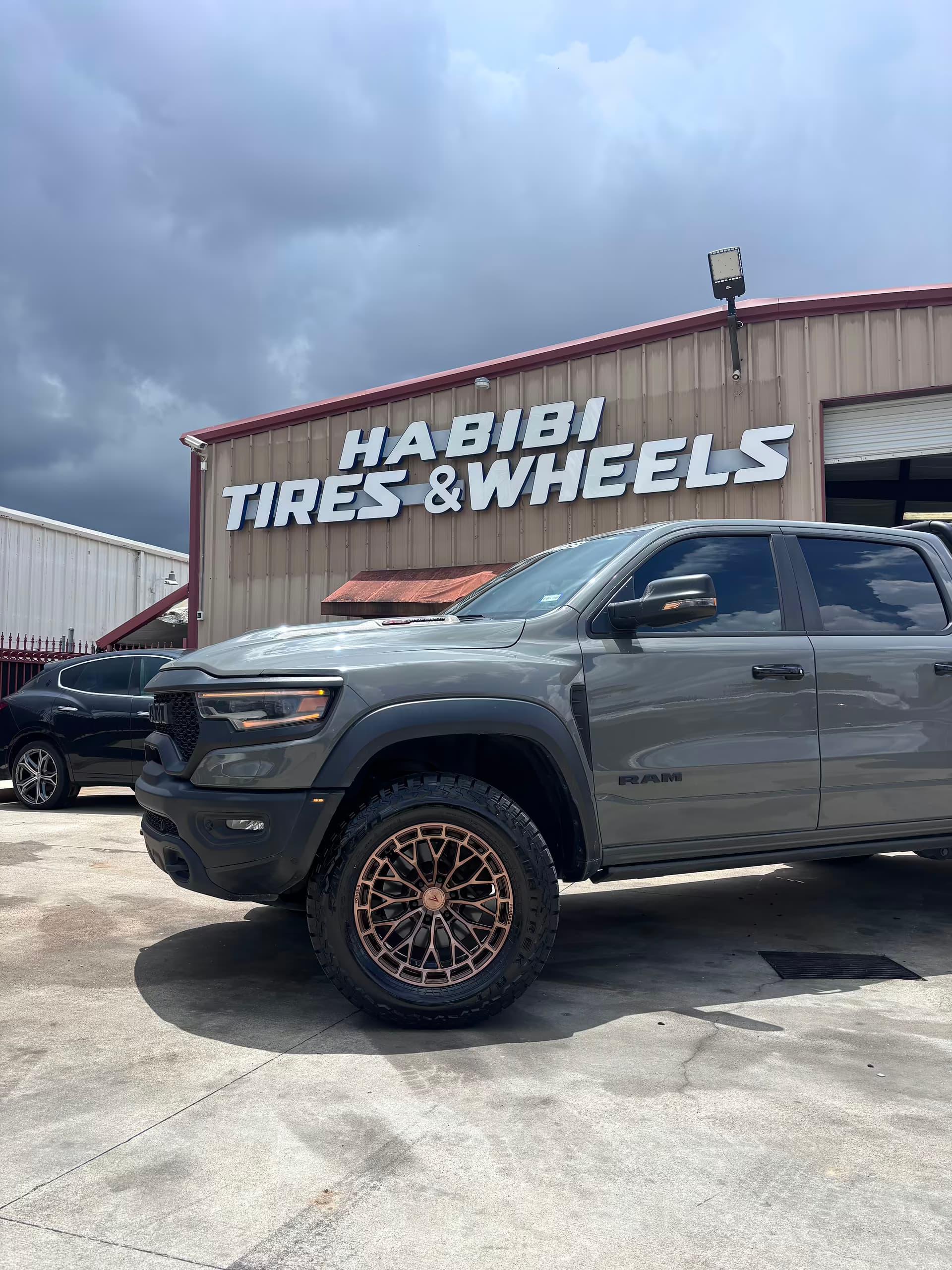 Completed gray RAM with bronze wheels outside Habibi Tires and Wheels
